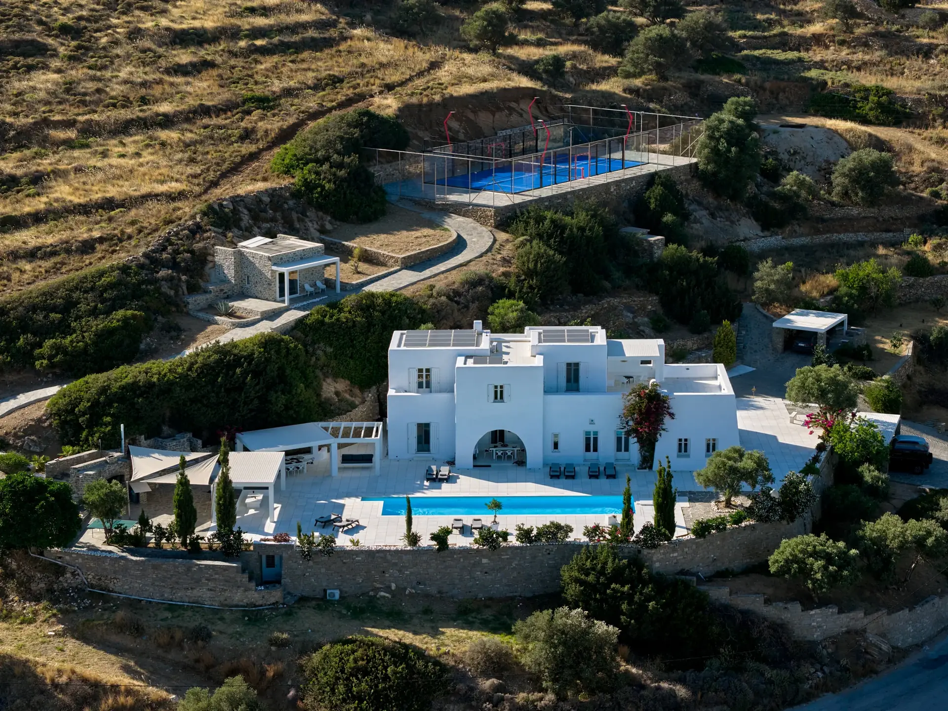 Daytime aerial view of Padel Villa Paros, its private pool and Wilson padel court