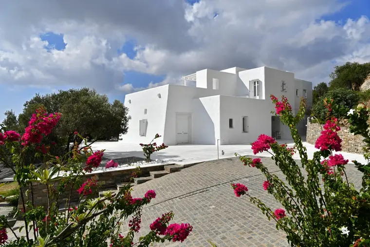White Cycladic exterior framed by bougainvillea