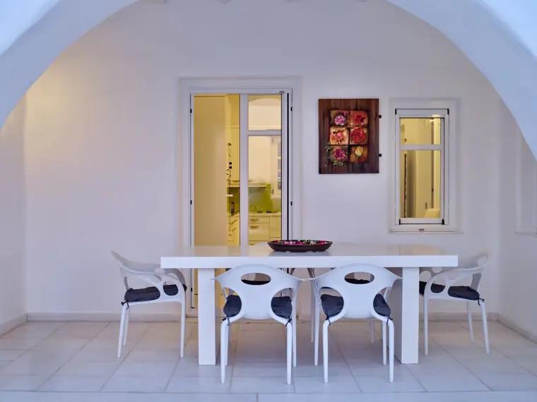 Arched outdoor dining area opening toward the pool