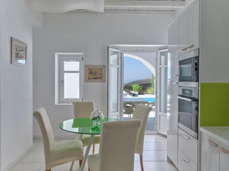 Kitchen breakfast area with doors to the pool terrace