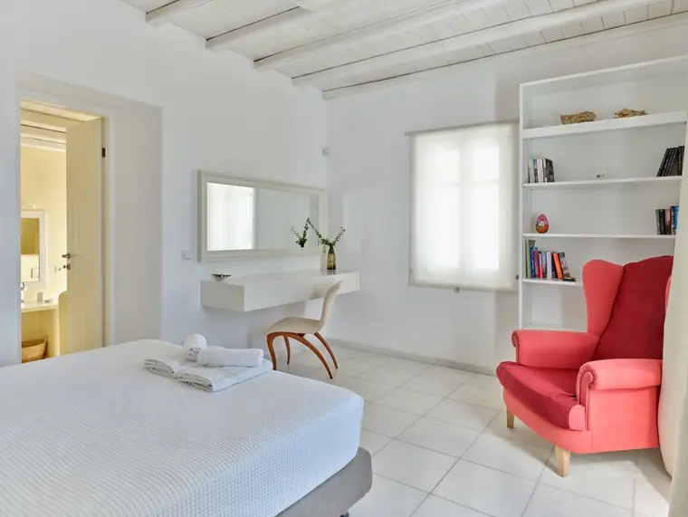 Double bedroom with en-suite bathroom and red reading chair