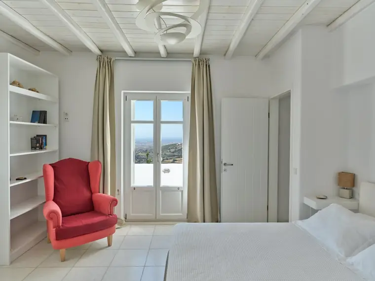 Sea-view double bedroom with red reading chair