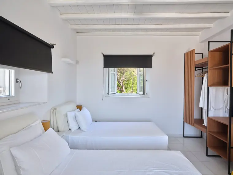 Twin bedroom with garden view and custom wardrobes