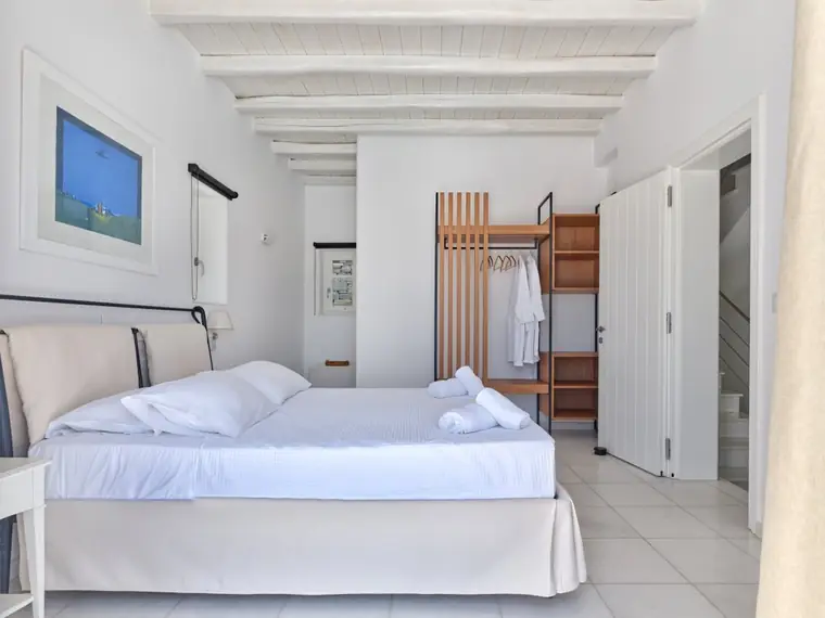 Main-house double bedroom with natural wood wardrobe