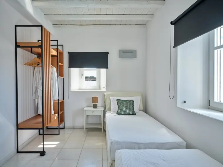 Twin bedroom with two single beds and soft natural light