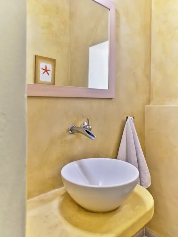 Compact warm-toned bathroom with vessel basin