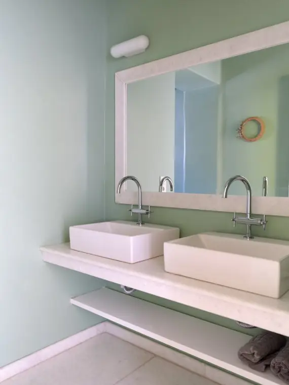 Pale green bathroom with twin basins