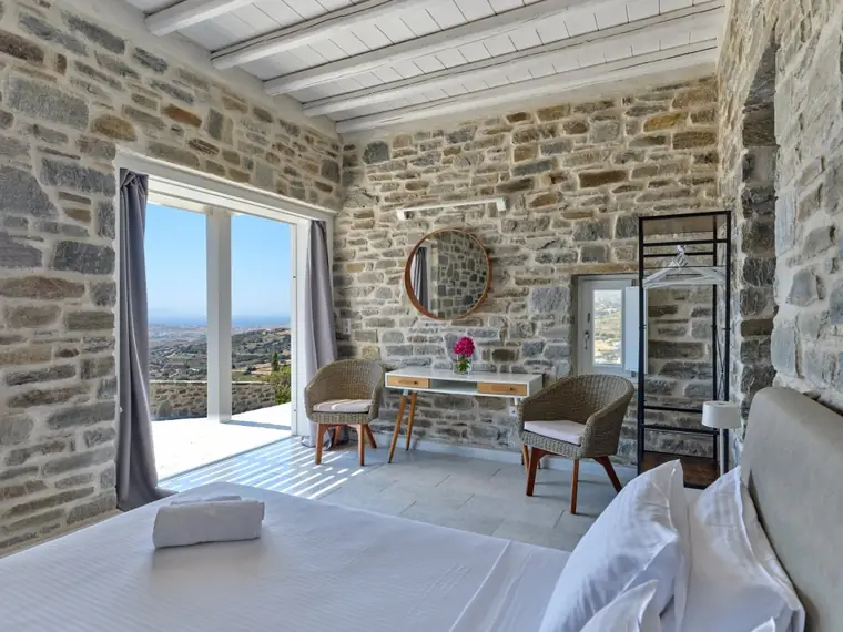 Stone guest-house bedroom with broad valley view