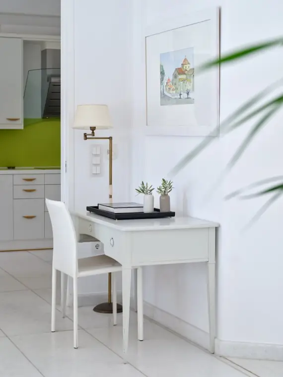 Writing desk and artwork beside the kitchen