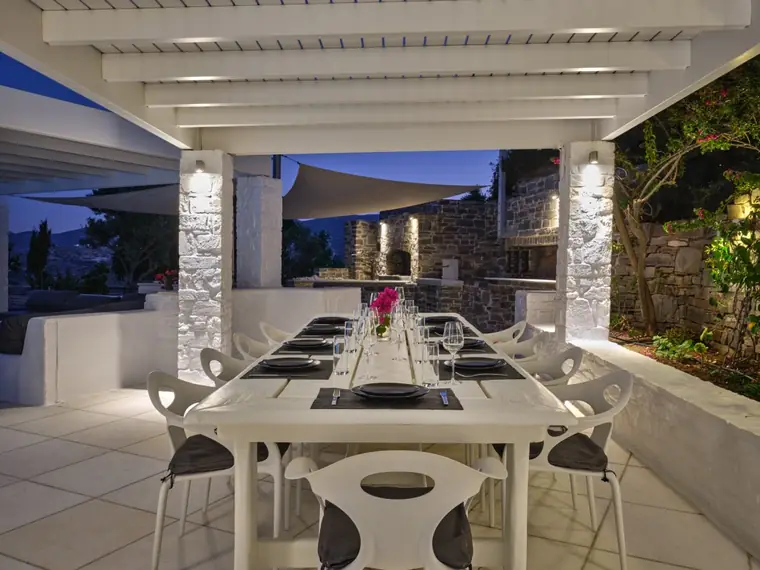 Pergola dining table prepared for an evening meal