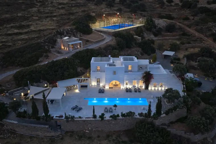 Night aerial view of the villa, pool and padel court